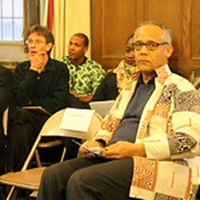 group of people listening to a presentation